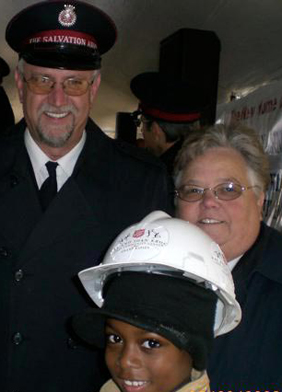 Majors Roger and Joy Ross, chief administrators of the Kroc Center, and Jaylen Jennings, a Kroc Leadership Academy student, are seen at the groundbreaking ceremonies for the new family center. Neighborhood children like Jaylen are already attending Kroc programs taking place in their nearby grade schools: New Branches and Brookside.